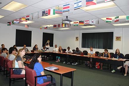 people sitting at tables in a classroom